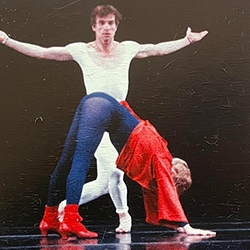Thumbnail photo of Four dancers on stage men in white woman in red and blue