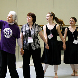 Thumbnail photo of Group of dancers holding hands woman leading