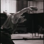 Thumbnail of Man looking down with arms to the side