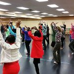 Thumbnail of Woman dancing together with arms in the air