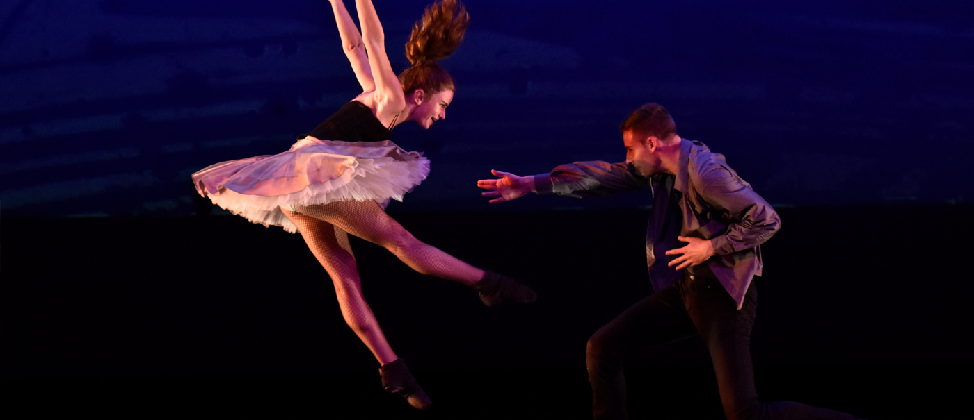 Woman jumping backwards and man reaching towards