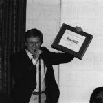 Thumbnail of man holding an award