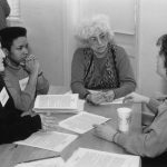 Thumbnail of four people seated in discussion