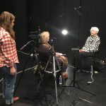 Thumbnail of Two women in an interview, one filming