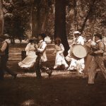 Thumbnail of group of people in a park a few playing drums