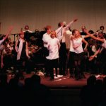 Thumbnail of group of dancers in white shirts with musicians