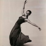 Thumbnail of Woman in long dress leaning back with arms up in air