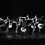 Thumbnail of Seven dancers on stage circular props on feet