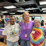 Thumbnail of three women posing, smiling hugging