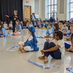 Thumbnail of group of students seated in a studio listening to a teacher speak