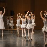 Thumbnail of group of dancers in white dresses arms in air