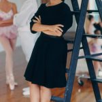 Thumbnail of girl leaning on ladder man and female dancer behind