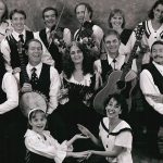 Thumbnail of group of people posing some with instruments