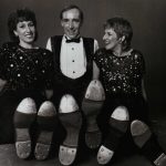 Thumbnail of two women and a man posing with bottom of tap shoes to audience